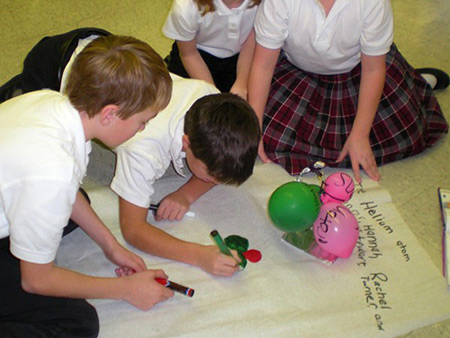 Students work on a project in science class at St. Isaac Jogues last year. The school is investing $80,000 into a new, state-of-the art trademarked science program LabLearner