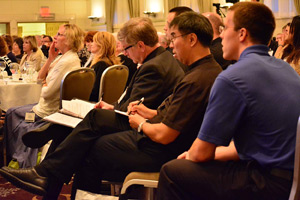 Clergy and lay ministers take notes during several of the presentations. "The purpose of Courage is not to change people's sexual attractions, " said Dr. Timothy Lock, Courage board member.