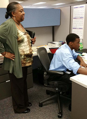 A Loyola student is supervised while working for DTE Energy as part of his school's Work Experience Program, which prepares juniors and seniors with real-world experience.