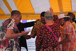 Evangelist Richard Lane prays with parishioners of St. Charles Lwanga Parish in Detroit during a revival July 27.