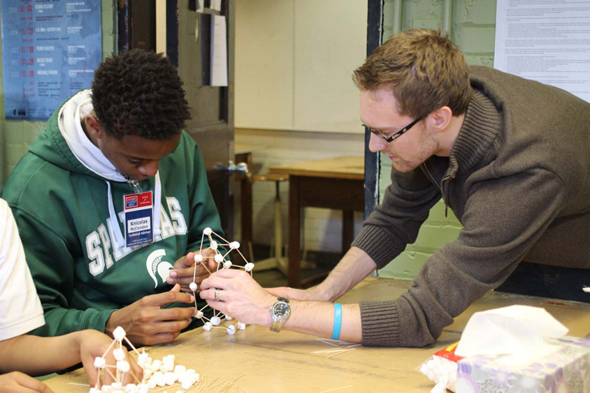 A University of Detroit Mercy work-study student works on a science project with Gesu student Knicholas McClendon. UDM, along with Marygrove College, has been sending its own students to work with Gesu for credit and experience.