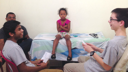 Parishioners of St. Owen Parish in Bloomfield Hills entertain a young patient during a mission trip to their "sister parish," the Church of the Good Shepherd in Haina, Dominican Republic.