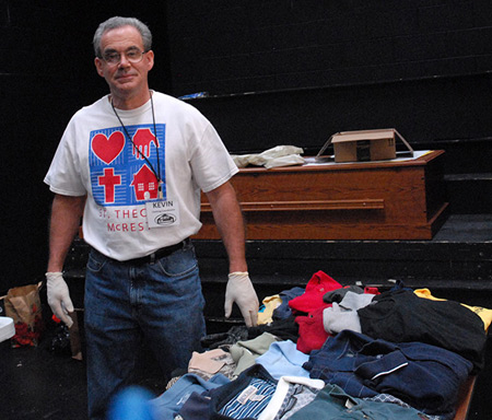 St. Thecla parishoner Kevin Kuhn sorts through the clothes that are to be given away to MCREST guests.