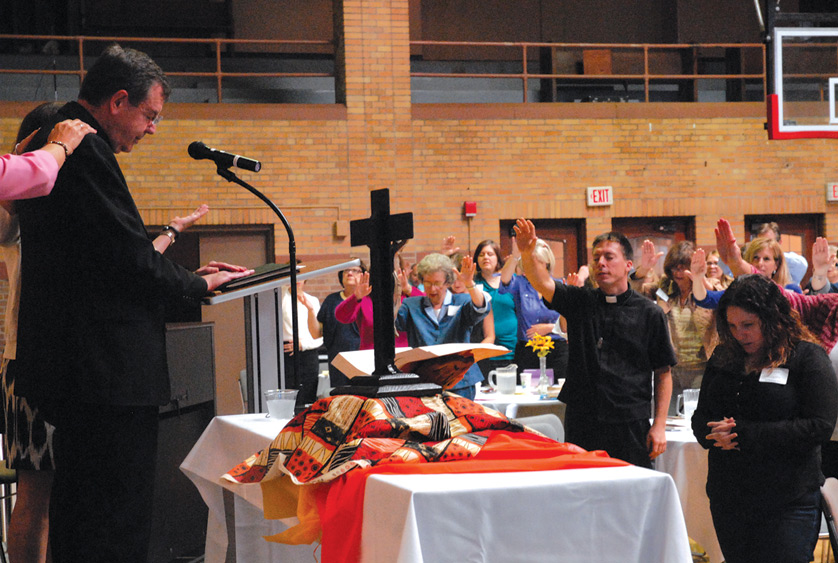 Parish leaders pray over Archbishop Allen Vigneron on Sept. 10 during an annual gathering at Sacred Heart Major Seminary in Detroit. Dan Meloy | The Michigan Catholic