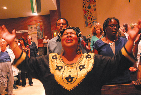 A woman sings passionately at Corpus Christi Parish in Detroit during the first night of "Amazing Grace Overcoming Race," an event of Hope and Purpose Ministries and part of the Archdiocese of Detroit's evangelization initiative. 