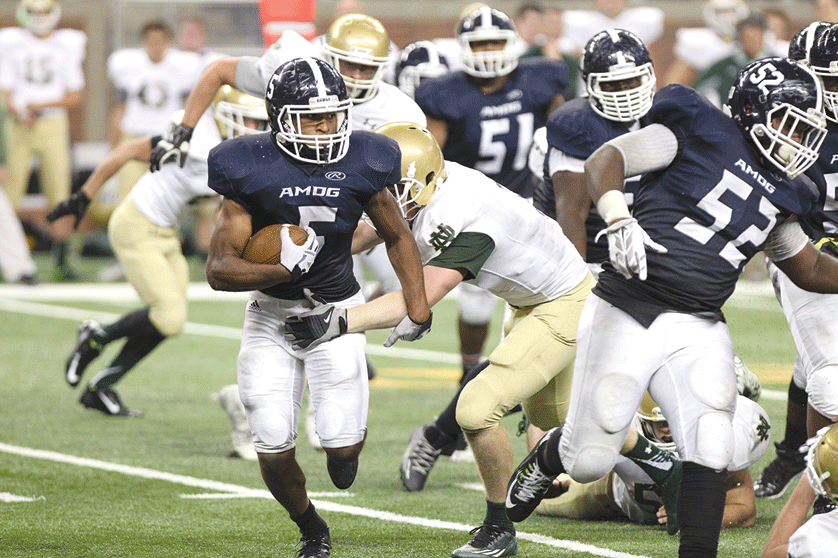 Bulldogs senior Trevon Vaughn breaks away from Irish defenders during Detroit's Loyola's 40-10 win over Pontiac Notre Dame Prep for the Prep Bowl intersectional title. The victory was Loyola's sixth straight Prep Bowl triumph. Mr. Mack Photography