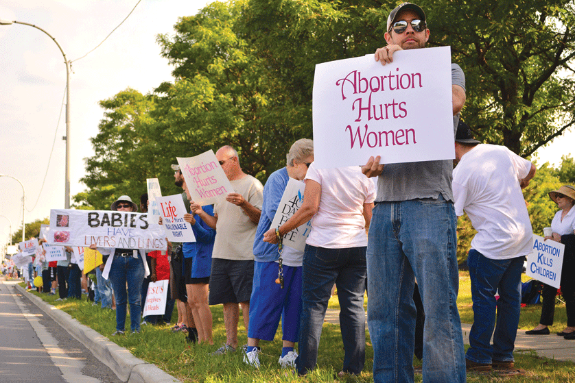 Protesters line the streets outside a Planned Parenthood clinic in Warren in August to call for the defunding of the abortion giant and the protection of unborn life.