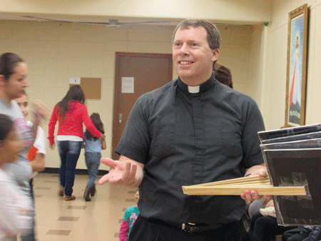 Fr. James Kean Jokes around with religious education students at St. Damien of Molokai Parish in Pontiac, where he's been pastor for six years. Kelly Luttinen | Special to The Michigan Catholic