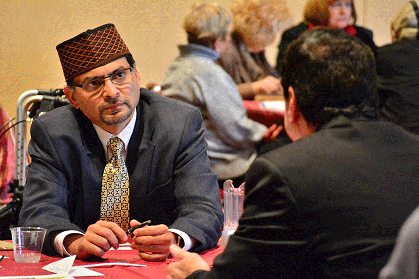 Mansoor Qureshi, president of the Rochester-based Ahmadiyya Muslim Community, listens to St. Thomas More pastor Msgr. Thomas Rice during an October 18 interfaith event at the Troy parish. The South Oakland Vicariate Justice and Peace Committee helped organize the event in collaboration with the local Muslim Community.