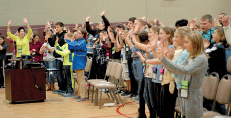 Middle school students clap and sing during a jam session at St. Germaine School in St. Clair Shores as part of the Catholic Youth Organization's annual WIND conference. Dan Meloy | The Michigan Catholic