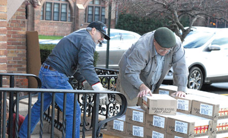 Volunteers of Transfiguration Parish's Franciscan Outreach Program unload boxes of food Nov.19 for its 2015 holiday distribution, which to date has served more than 1,000 families in need and is among the largest in the Archdiocese of Detroit. Dan Meloy | The Michigan Catholic