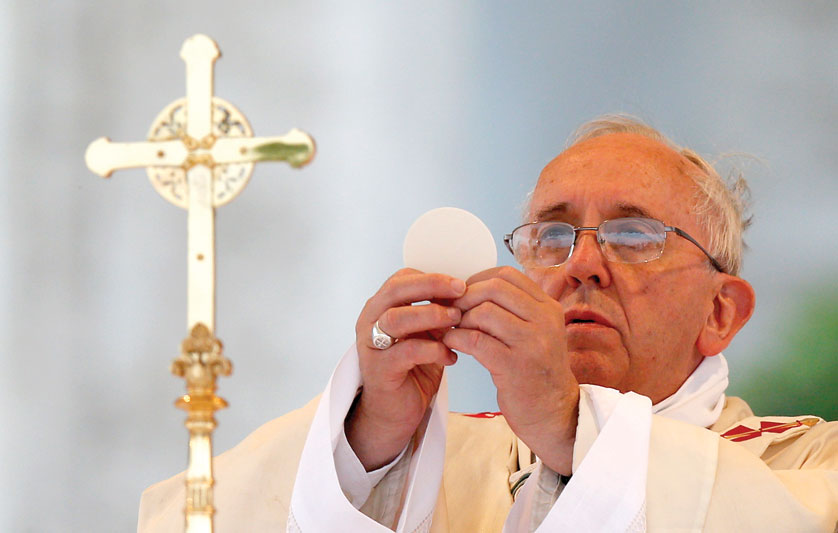 Pope Francis elevates the Eucharist as he celebrates Mass on the feast of Corpus Christi outside the Basilica of St. John Lateran in 2014. Was Jesus' teaching about His Eucharistic presence simply a case of misunderstanding? It doesn't appear so. Paul Haring | CNS Photo