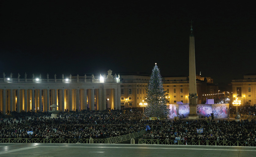 An overflow crowd of several thousand people in St. Peter's Square are seen after watching Pope Francis celebrate Christmas Eve Mass in St. Peter's Basilica at the Vatican last year. Paul Haring | CNS Photo
