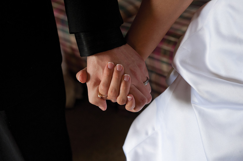 A groom and bride hold hands on their wedding day. The Catholic teaching on sexuality as reserved to a husband and wife within the context of a marriage open to conception has often been the subject of misunderstanding and derision, but the Church has good reasons for what it teaches. Jon L. Hendricks | CNS file photo