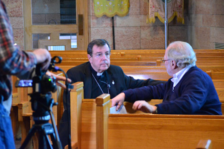 Archbishop Allen H. Vigneron speaks with Lucy Severson, a reporter for PBS' Religion and Ethics Newsweekly, on Jan. 14 at St. Ladislaus Church in Hamtramck. Photos by Mike Stechschulte | The Michigan Catholic