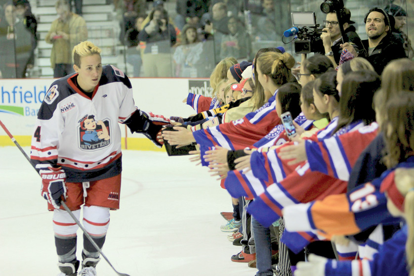 New York Riveters forward Madison Packer, a 2010 graduate of Bloomfield Hills Marian High School, high-fives young fans before a game earlier this season. Packer plays in the start-up National Women's Hockey league, the first professional women's league in the United States. Photo by National Women's Hockey League