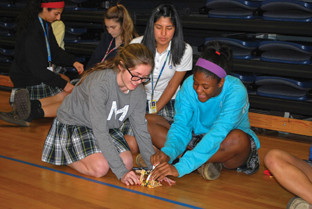Marian High School students work to build machines as part of the school's new STEM club, which introduces students to professionals working in fields such as engineering, science, and math. Photos by Marian High School