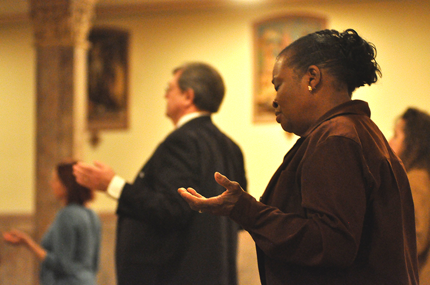 A woman prays during Ash Wednesday Mass at St. Aloysius Parish in Detroit in 2012. For a new Lenten encounter, local Jesuits recommend Ignatian spiritual exercises — in which a person places himself or herself alongside Jesus in the Scriptures — as a way to grow closer to God on a daily basis.