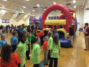Students line up for the bounce house at Cardinal Mooney High School during the school's first Catholic Schools Week Carnival on Feb. 1.