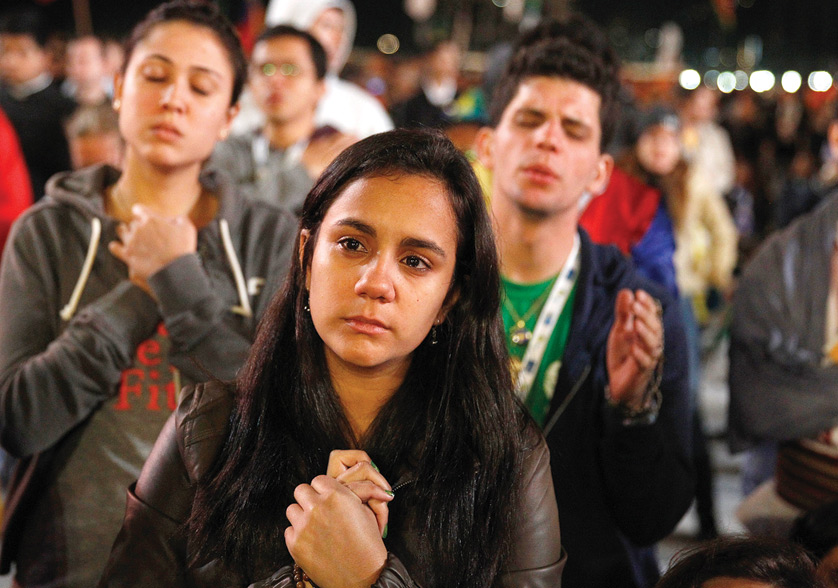 Young people pray during Eucharist adoration led by Pope Francis at the World Youth Day vigil on Copacabana beach in Rio de Janeiro in 2013.  Paul Haring| CNS Photo