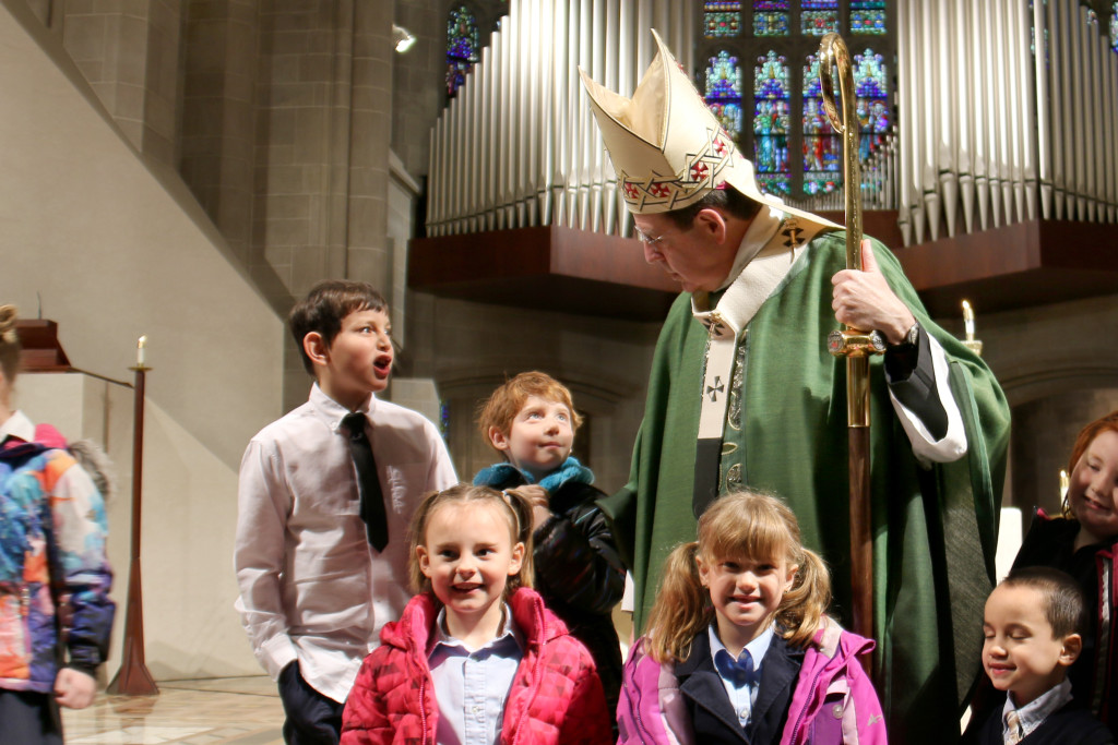 Archbishop Allen H. Vigneron shares a moment and a picture with Catholic school students at the Cathedral of the Most Blessed Sacrament at the conclusion of the annual Mass for Catholic Schools Week on Feb. 4. During the Mass, students from schools across the Archdiocese of Detroit gathered to worship and hear advice from Archbishop Vigneron about the mission and purpose of Catholic schools. (Photos by Annie Schunior | Archdiocese of Detroit)