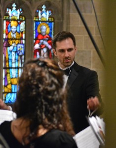 Archdiocesan Chorus director Joe Balistreri leads the choir in song during the Chrism Mass.
