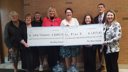 Principals from Detroit-area Catholic schools present checks March 8 to principals from St. Pius X School and St. John Vianney School in Flint the wake of the fallout from the city's water crisis. Courtesy of Melissa Lambrecht