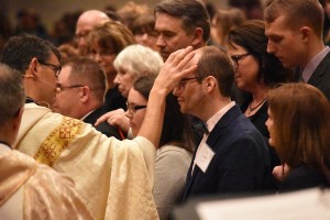 Fr. John Riccardo anoints Matthew Beitel to confirm him during the Easter Vigil at Our Lady of Good Counsel.