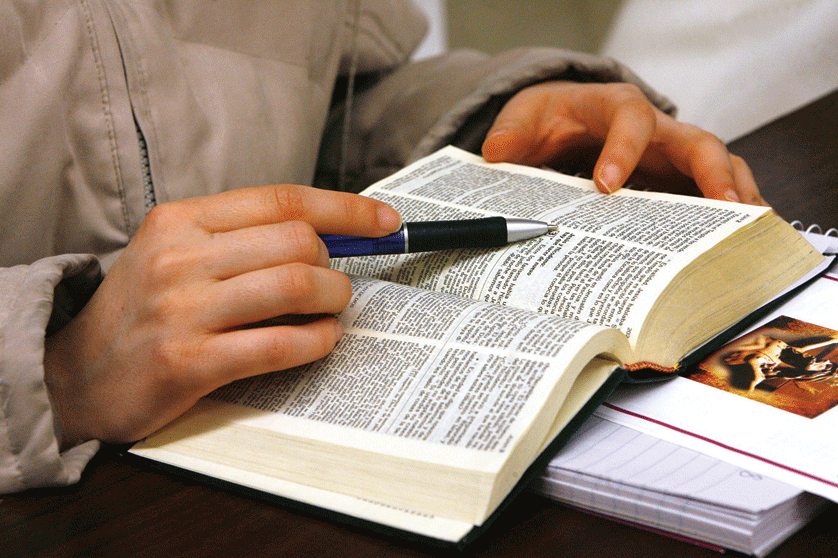 A young woman studies the Bible in this 2009 file photo. Pope Francis has repeatedly encourage the faithful to carry a pocket-sized Bible and to read several verses a day. Karen Callaway | CNS Photo