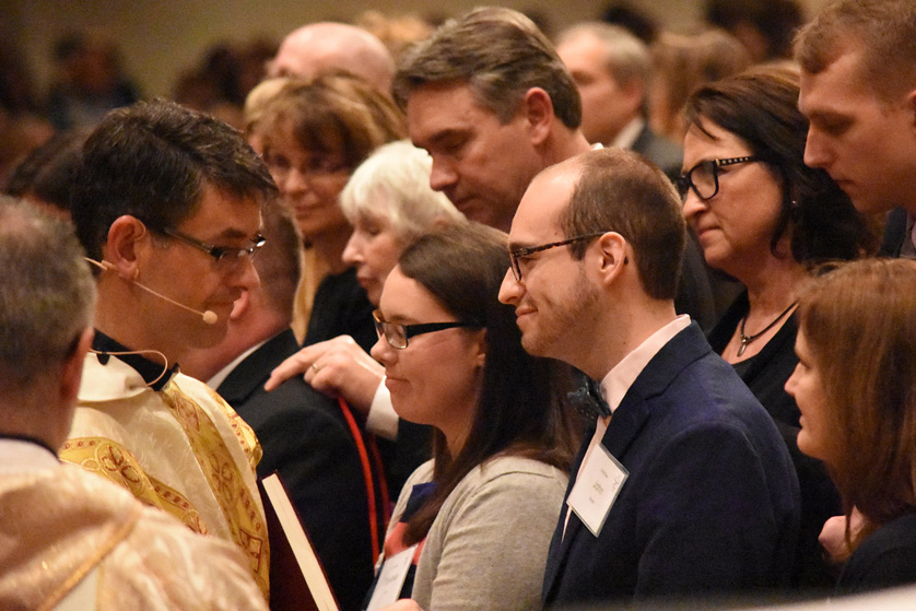 Fr. John Riccardo prepares to anoint Matthew Beitel during the Easter Vigil at Our Lady of Good Counsel Parish in Plymouth. Beitel, who entered the Catholic Church after a dream in which he said he found himself standing before the Blessed Sacrament, received confirmation and first Communion during the Easter liturgy. (Dan Meloy | The Michigan Catholic)