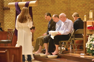 Fr. Aaron Smith, LC, washes the feet of parishioners at St. Daniel Parish in Clarkston during the Mass of the Lord’s Supper on Holy Thursday evening. (Mike Stechschulte | The Michigan Catholic)