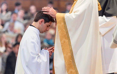 Bishop Kevin C. Rhoades of the Diocese of South Bend, Ind., ordains Rochester Hills native Fr. Dennis Strach II to the priesthood for the Congregation of Holy Cross on April 2 at the Basilica of the Sacred Heard in Notre Dame, Ind. Matt Cashore | University of Notre Dame