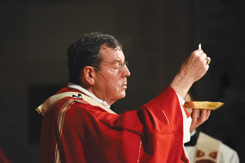 Archbishop Allen H. Vigneron elevates the Eucharist during the vigil Mass of Pentecost on May 14 at the Cathedral of the Most Blessed Sacrament. The archbishop called on Catholics to view Pentecost as a precursor to the outpouring of the Holy Spirit on the Archdiocese of Detroit, which he said he hopes will occur during and after the Synod '16. Photos by Dan Meloy | The Michigan Catholic