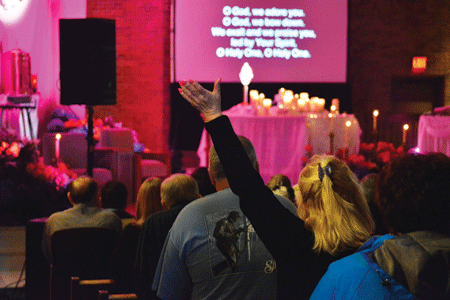 A woman prays with hands lifted during "Come, Encounter Christ!" at St. Ephrem Parish in Sterling Heights on May 2. Photos by Mike Stechschulte|The Michigan Catholic