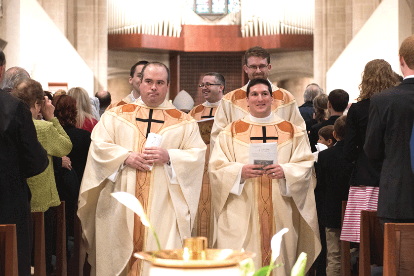 Fr. Paul Graney, left, and Fr. Dominic Macioce process with their classmates out of the Cathedral of the Most Blessed Sacrament after being ordained priests May 14 by Archbishop Allen H. Vigneron. Photos by Tim Fuller | Special to The Michigan Catholic