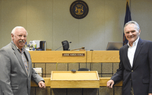 Gary Hinkle, left, and Paul Daniel stand in the courtroom of Judge Karen Khalil of the Veterans Court in Redford Township. Hinkle and Daniel, parishioners of St. Colette Parish in Livonia, volunteer to mentor fellow veterans at the court, which meets once a month. Dan Meloy | The Michigan Catholic