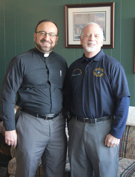 Fr. Joe Mallia, outgoing pastor of St. Frances Cabrini Parish in Allen Park, ,stands with Greg Campbell, director of the Cabrini Dream Mentor Program, which the two designed to help Cabrini students succeed after high school. Courtesy of Julie Lollo