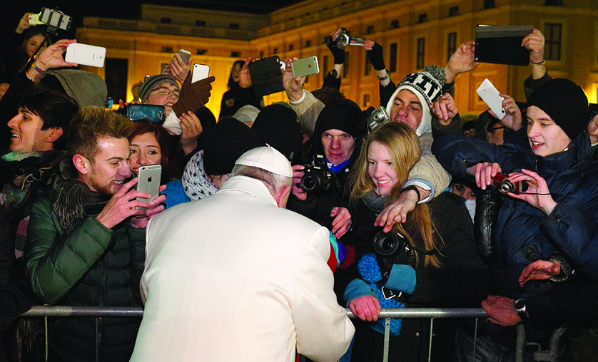 Pope Francis greets people after visiting the Nativity scene in St. Peter's Square after a New Year's Eve prayer service in St. Peter's Basilica at the Vatican. (CNS photo/Paul Haring) See POPE-YEAREND Dec. 31, 2014.