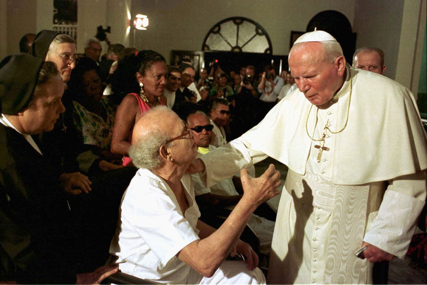 Pope St. John Paul II is pictured blessing patients suffering from AIDS and leprosy during a visit to Cuba in 1998. The pope, who himself waged a very public battle with Parkinson's disease during the last years of his life, is a model for how Christians should view suffering as an extension of Christ's own suffering. Arturo Mari, L'Osservatore Romano | CNS Photo