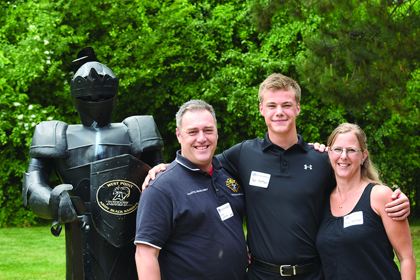 Ben Watson, a graduate of Saline High School and a member of St. Andrew Parish in Saline, stands with his parents at a picnic for new recruits who will attend the United States Military Academy at West Point this fall.