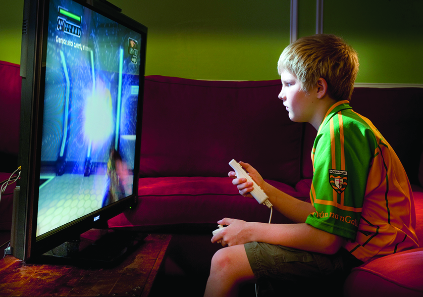 A boy is pictured in a photo illustration playing a teen-rated video game. As a case concerning violent video gaming approaches a hearing at the U.S. Supreme Court, psychologists and others debate whether violent games conflict with Catholic morals.(CNS photo/Lisa A. Johnston) (July 19, 2010) See GAMING July 19, 2010.