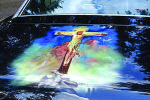 Starting from the front driver’s side quarter panel, Dennis Hatmaker’s car depicts 10 scenes from salvation history, starting with the Annunciation and ending with Pentecost, as well as images of the Sacred Heart of Jesus, Our Lady of Grace and quotations from sacred Scripture. To see more photos, visit gallery.themichigancatholic.com.