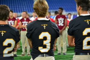Everest Collegiate High School football players sport jerseys that say "All for Him" on the back.