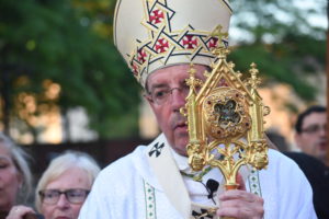 Archbishop Allen H. Vigneron holds a relic of St. Anne during her feast day celebration.
