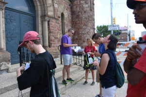 Young adults gaze up at Our Lady of the Rosary Church in Detroit while on a six-mile walking pilgrimage from the Cathedral of the Most Blessed Sacrament to Ste. Anne de Detroit Parish. 
