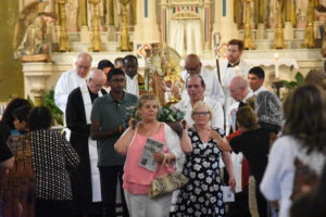 A statue of St. Anne and the Blessed Virgin Mary are carried in procession out of Ste. Anne de Detroit Church. 