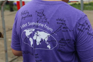 A pilgrim wears a shirt showing the different countries of fellow travelers during World Youth Day in Poland.