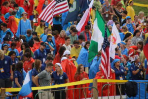 A sea of pilgrims from a multitude of countries wait in the rain for the opening Mass of World Youth Day in Krakow, Poland.