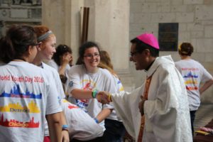 Archdiocese of Detroit pilgrims laugh with Auxiliary Bishop Arturo Cepeda while on pilgrimage in Krakow. 