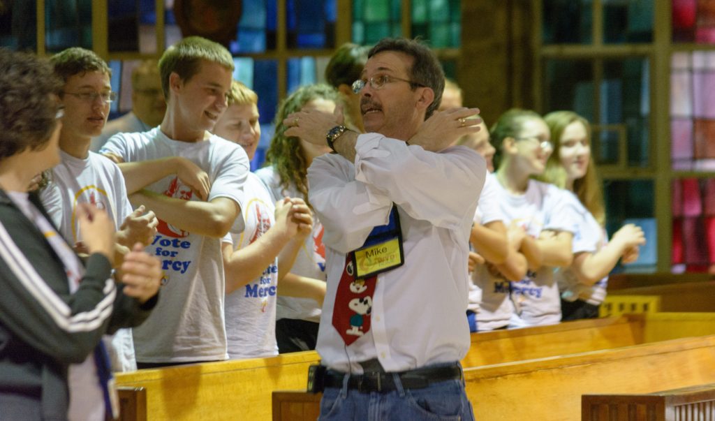 Youth speaker Mike Patin leads teens in a song during his energetic talk on mercy during the World Youth Day home event July 30 at the Orchard Lake Schools. (Photos by Mike Stechschulte | The Michigan Catholic)